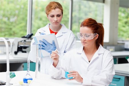 simsearch:400-05670362,k - Young science students doing an experiment in a laboratory Stock Photo - Budget Royalty-Free & Subscription, Code: 400-05670587