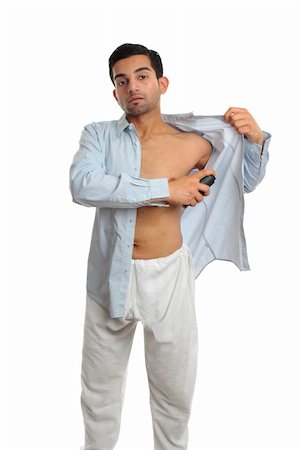A man using an underarm deodorant perspirant aerosol spray white getting dressed prepared to go out. White background, Stock Photo - Budget Royalty-Free & Subscription, Code: 400-05670595