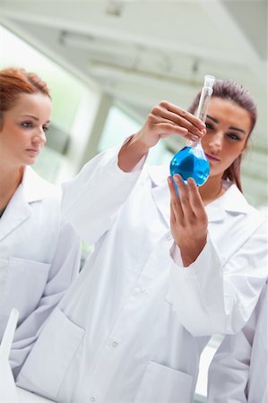 students in physics lab - Portrait of scientists looking a flask in a laboratory Stock Photo - Budget Royalty-Free & Subscription, Code: 400-05670617