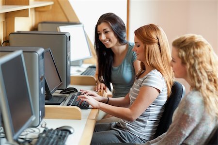 simsearch:400-05684311,k - Smiling students working together in an IT room Stock Photo - Budget Royalty-Free & Subscription, Code: 400-05670657