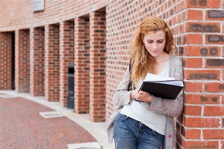 Young student reading her notes outside a building Stock Photo - Budget Royalty-Free & Subscription, Code: 400-05670710