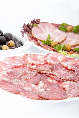 simsearch:400-06852716,k - Cutting sausage and meat on a celebratory table. Stockbilder - Microstock & Abonnement, Bildnummer: 400-05670946