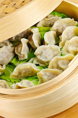 Closeup of bamboo steamer with cooked dumplings Stock Photo - Budget Royalty-Free & Subscription, Code: 400-05671199