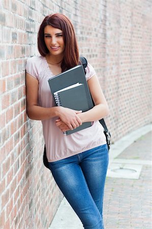 Portrait of a smiling student holding her binders outside the building Stock Photo - Budget Royalty-Free & Subscription, Code: 400-05672196