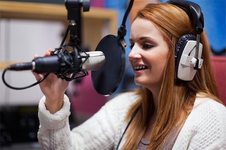 deejay (female) - Happy radio host speaking through a microphone Stock Photo - Budget Royalty-Free & Subscription, Code: 400-05672208