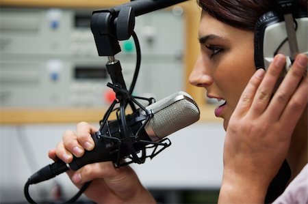 Close up of a gorgeous singer recording a track in a studio Photographie de stock - Aubaine LD & Abonnement, Code: 400-05672214