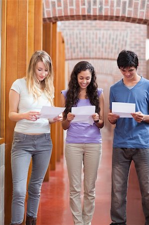 school awards - Portrait of students reading a piece of paper in a corridor Stock Photo - Budget Royalty-Free & Subscription, Code: 400-05684029