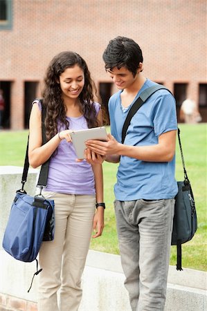 students tablets outside - Portrait of a couple holding a tablet computer outside a building Stock Photo - Budget Royalty-Free & Subscription, Code: 400-05684097