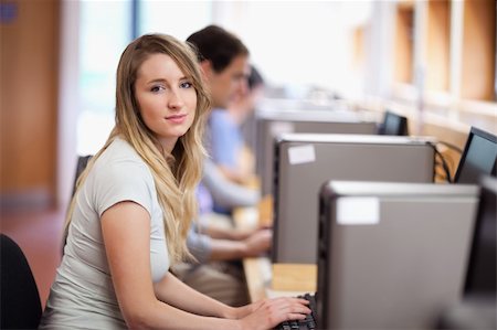 simsearch:400-05684311,k - Blonde student using a computer in an IT room Stock Photo - Budget Royalty-Free & Subscription, Code: 400-05684106