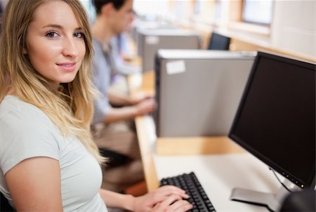 simsearch:400-05684311,k - Cute student with a computer in an IT room Stock Photo - Budget Royalty-Free & Subscription, Code: 400-05684114