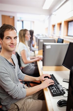 simsearch:400-05684311,k - Portrait of a serious male student working with a computer in an IT room Stock Photo - Budget Royalty-Free & Subscription, Code: 400-05684123
