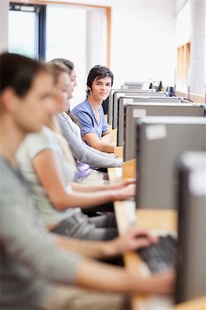 simsearch:400-05684311,k - Portrait of young fellow students in an IT room with the camera focus on the background Stock Photo - Budget Royalty-Free & Subscription, Code: 400-05684130