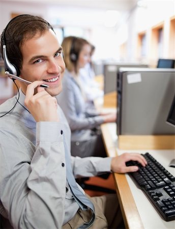 Portrait of an assistant using a headset in a call center Stock Photo - Budget Royalty-Free & Subscription, Code: 400-05684296
