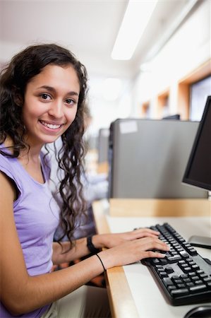 simsearch:400-05684311,k - Portrait of a cute smiling student with a computer in an IT room Stock Photo - Budget Royalty-Free & Subscription, Code: 400-05684313