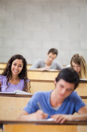 simsearch:400-05684337,k - Portrait of students during a lecture with the camera focus on a model Photographie de stock - Aubaine LD & Abonnement, Code: 400-05684331