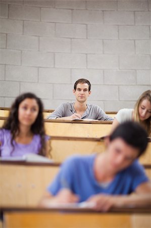 simsearch:400-05684320,k - Portrait of young students during a lecture with the camera focus on the background Stock Photo - Budget Royalty-Free & Subscription, Code: 400-05684332