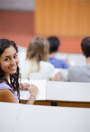 simsearch:400-05684360,k - Portrait of a cute student being distracted in an amphitheater Stock Photo - Budget Royalty-Free & Subscription, Code: 400-05684367