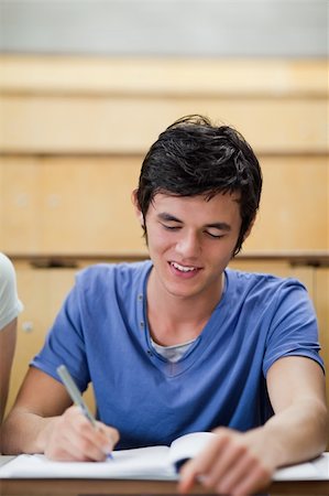 simsearch:400-05684361,k - Portrait of a handsome young student taking notes in an amphitheater Stock Photo - Budget Royalty-Free & Subscription, Code: 400-05684386
