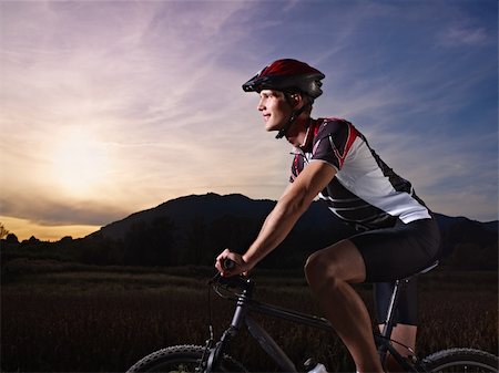 sports activity: young adult cyclist riding mountain bike in the countryside. Horizontal shape, side view, copy space Stock Photo - Budget Royalty-Free & Subscription, Code: 400-05684470