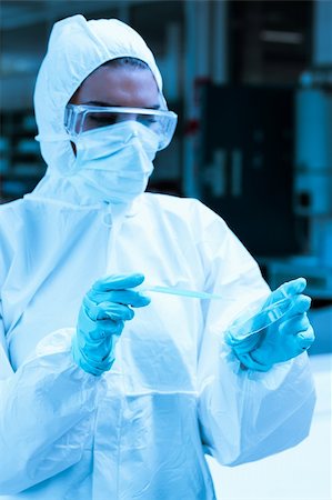 Protected scientist dropping dangerous liquid in a Petri dish in a sterile laboratory Stock Photo - Budget Royalty-Free & Subscription, Code: 400-05684525