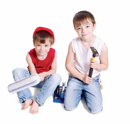 simsearch:400-05876095,k - Two young workers with paint roller and hammer isolated on white background Stock Photo - Budget Royalty-Free & Subscription, Code: 400-05685636