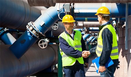 Two engineers meeting outside at the piping of an industrial waste water cleaning facility Stock Photo - Budget Royalty-Free & Subscription, Code: 400-05686444