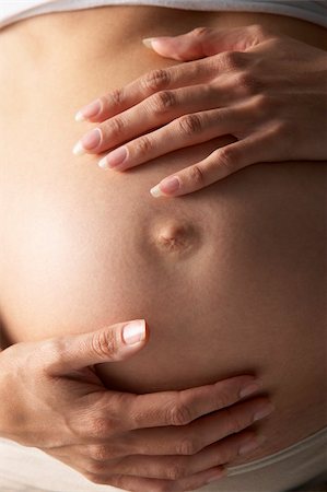 pregnancy nude - Detail Of Pregnant Woman Holding Stomach Foto de stock - Super Valor sin royalties y Suscripción, Código: 400-05686485