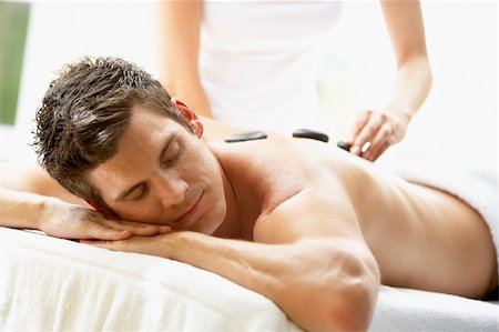simsearch:400-05686717,k - Young Man Enjoying Hot Stone Treatment Stock Photo - Budget Royalty-Free & Subscription, Code: 400-05686668