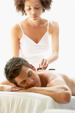 simsearch:400-05686717,k - Young Man Enjoying Hot Stone Treatment Stock Photo - Budget Royalty-Free & Subscription, Code: 400-05686669