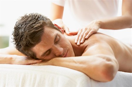 simsearch:400-05686719,k - Young Man Enjoying Massage At Spa Fotografie stock - Microstock e Abbonamento, Codice: 400-05686672