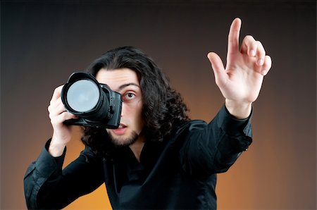 paparazzi taking pictures of man background - Photographer with the digital camera Stock Photo - Budget Royalty-Free & Subscription, Code: 400-05687671