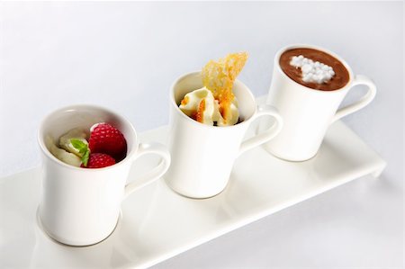 A picture of three different desserts in mugs over white background Photographie de stock - Aubaine LD & Abonnement, Code: 400-05688540