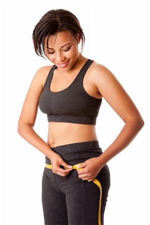 Beautiful happy toned woman weight conscious measuring her size shape around waist hips dressed sporty in grey, isolated. Stock Photo - Budget Royalty-Free & Subscription, Code: 400-05680232