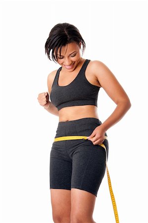Beautiful happy toned woman weight conscious measuring her size shape around waist hips, celebrating her successful weightloss, dressed sporty in grey, isolated. Stock Photo - Budget Royalty-Free & Subscription, Code: 400-05680233