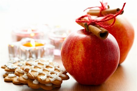 Close-up of delicious red Christmas apples with cinnamon sticks, gingerbread cookies and candles Stock Photo - Budget Royalty-Free & Subscription, Code: 400-05680675