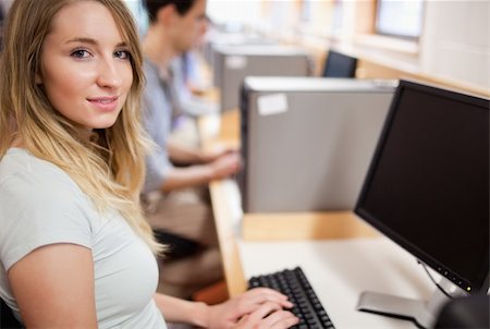 simsearch:400-05684311,k - Cute student with a computer in an IT room Stock Photo - Budget Royalty-Free & Subscription, Code: 400-05681044