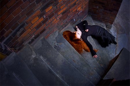 sad and quiet woman - Gothic girl dressed in black lie on stairway Stock Photo - Budget Royalty-Free & Subscription, Code: 400-05681159