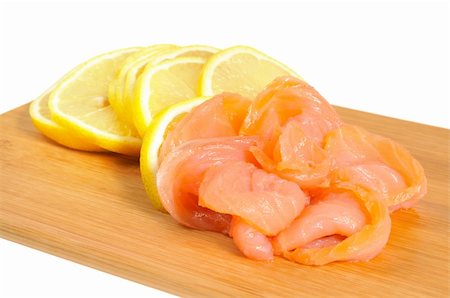 salmon pink - Salmon and lemon on wooden board. Isolated on white Stock Photo - Budget Royalty-Free & Subscription, Code: 400-05682300