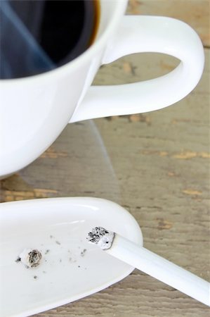 simsearch:400-06094947,k - Cigarette on ashtray with cup of steaming coffee Stock Photo - Budget Royalty-Free & Subscription, Code: 400-05683311