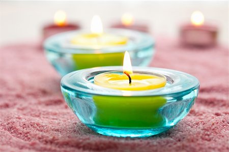 Close-up of yellow candles in glass holders on pink sand Stock Photo - Budget Royalty-Free & Subscription, Code: 400-05683369