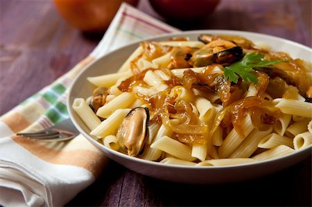 dinner table in italy - macaroni with mussels and sweet onion on wood backgroun Stock Photo - Budget Royalty-Free & Subscription, Code: 400-05683991