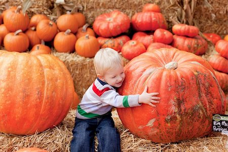 adorable toddler is hugging a huge pumpkin Stock Photo - Budget Royalty-Free & Subscription, Code: 400-05694099