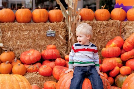 simsearch:400-07211170,k - playful caucasian toddler sitting on the huge pumpkin Photographie de stock - Aubaine LD & Abonnement, Code: 400-05694100