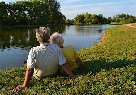 A senior couple sitting and relaxing together on a lakeside on a sunny afternoon. Stock Photo - Budget Royalty-Free & Subscription, Code: 400-05695371