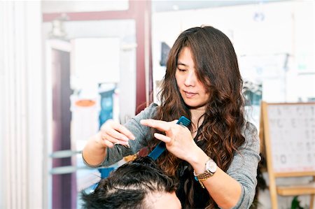 Happy hairdresser cutting hair in her salon Stock Photo - Budget Royalty-Free & Subscription, Code: 400-05695753