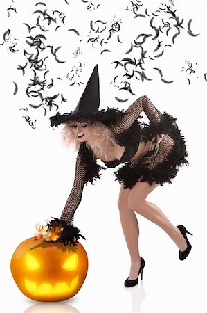 beautiful curled blonde wearing a black feathered witch costume and high heels Stock Photo - Budget Royalty-Free & Subscription, Code: 400-05696306