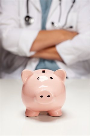 simsearch:400-04758612,k - Female Doctor with Folded Arms Behind Piggy Bank Abstract. Stock Photo - Budget Royalty-Free & Subscription, Code: 400-05696389