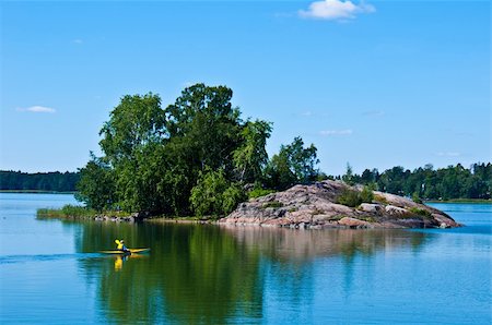 peaceful finnish scenery in Helsinki with a canoe in the distance Stockbilder - Microstock & Abonnement, Bildnummer: 400-05696474