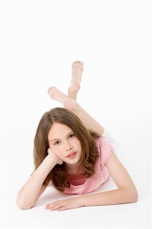 Young Girl Lying On Stomach In Studio Stock Photo - Budget Royalty-Free & Subscription, Code: 400-05696987