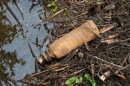 plastic can - plastic bottle thrown away in a ditch Stock Photo - Budget Royalty-Free & Subscription, Code: 400-05697055